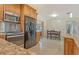 Open floor plan in kitchen featuring wood cabinets, granite countertops, and stainless steel appliances at 568 Sheridan Dr, Venice, FL 34293