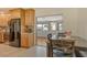 Kitchen features wood cabinets, granite countertops, and open floor plan views of dining room at 568 Sheridan Dr, Venice, FL 34293