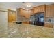 Beautiful kitchen featuring granite countertops, wood cabinets, and stainless steel appliances at 568 Sheridan Dr, Venice, FL 34293