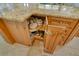 Kitchen island storage with a lazy susan cupboard filled with dishes and cookware at 568 Sheridan Dr, Venice, FL 34293
