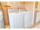 Laundry area featuring a modern washer and dryer with unfinished walls and a 'Wash & Dry' sign at 568 Sheridan Dr, Venice, FL 34293