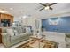 Well-lit living room features a comfortable sofa and seamless access to dining area and kitchen at 568 Sheridan Dr, Venice, FL 34293