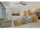 Comfortable living room showcasing a cozy seating area and seamless flow into the adjacent kitchen at 568 Sheridan Dr, Venice, FL 34293