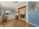 Comfortable living room with light wood floors leading to dining area at 568 Sheridan Dr, Venice, FL 34293