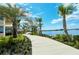 Scenic lakeside path with lush landscaping and serene water views, perfect for a relaxing walk or bike ride at 568 Sheridan Dr, Venice, FL 34293