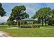 Picnic area with picnic tables and a grill under a green gazebo at 568 Sheridan Dr, Venice, FL 34293