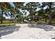 Playground with a swingset over a sand area and a play structure in the background at 568 Sheridan Dr, Venice, FL 34293