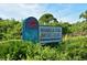 Welcoming sign for Shamrock Park Nature Center, surrounded by lush greenery and foliage on a beautiful day at 568 Sheridan Dr, Venice, FL 34293