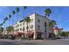 Historic KMI Building lined with palm trees and red awnings in downtown Venice at 568 Sheridan Dr, Venice, FL 34293