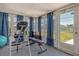 Bright sun room with gym equipment and an open backyard at 568 Sheridan Dr, Venice, FL 34293