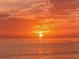 Breathtaking sunset over the ocean with vibrant orange skies, a serene scene, and the sun's reflection on the water at 568 Sheridan Dr, Venice, FL 34293