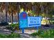 Welcoming Venice Beach sign nestled among palm trees, leading to Sarasota County's recreational beach area at 568 Sheridan Dr, Venice, FL 34293
