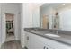 Elegant bathroom with double sinks, gray countertops, wood-look tile flooring, and a shower at 5759 Bungalow Grove Ct, Palmetto, FL 34221