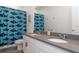 Bathroom featuring double sinks and a shower with a playful shower curtain featuring sharks at 5759 Bungalow Grove Ct, Palmetto, FL 34221