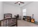 Cozy bedroom with neutral carpet, dark wood furniture, and a window for natural light and ventilation at 5759 Bungalow Grove Ct, Palmetto, FL 34221