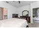 Bright bedroom with neutral walls and carpeting, plus dark wood furniture and a door to a sunroom at 5759 Bungalow Grove Ct, Palmetto, FL 34221