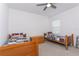 Cozy bedroom featuring two twin beds, ceiling fan, and neutral decor at 5759 Bungalow Grove Ct, Palmetto, FL 34221