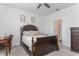 This bedroom features a dark wood bed frame and gray carpeting, with an ensuite bathroom attached at 5759 Bungalow Grove Ct, Palmetto, FL 34221