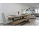 Dining room with a large wooden table and bench seating, next to the living area at 5759 Bungalow Grove Ct, Palmetto, FL 34221