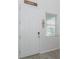 Bright entryway with a white front door, wood-look tile, and wall decorations at 5759 Bungalow Grove Ct, Palmetto, FL 34221