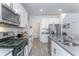 Modern kitchen featuring white cabinets, stainless steel appliances, and a gas range cooktop at 5759 Bungalow Grove Ct, Palmetto, FL 34221