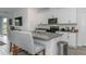 This bright kitchen has white cabinets, stainless appliances, and an island with barstool seating at 5759 Bungalow Grove Ct, Palmetto, FL 34221
