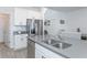 Beautiful kitchen with white cabinets, stainless steel appliances, and an island overlooking the dining area at 5759 Bungalow Grove Ct, Palmetto, FL 34221