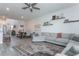 Open-concept living room flows into the dining area with an elegant rug and neutral color palette at 5759 Bungalow Grove Ct, Palmetto, FL 34221