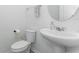 Clean powder room with a pedestal sink, toilet, and a decorative mirror at 5759 Bungalow Grove Ct, Palmetto, FL 34221