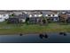 Picturesque backyard view with screened-in pools overlooking a serene pond, creating a relaxing outdoor oasis at 5772 Bluestar Ct, Bradenton, FL 34211