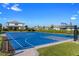 Enjoy a game on the community's blue basketball court, surrounded by lush landscaping, under a sunny sky at 5772 Bluestar Ct, Bradenton, FL 34211