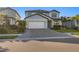 Two-story home with brick driveway, a two-car garage, and manicured landscaping at 5772 Bluestar Ct, Bradenton, FL 34211