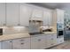 Well-appointed kitchen with white cabinets, mosaic backsplash, granite countertops, and stainless steel appliances at 5772 Bluestar Ct, Bradenton, FL 34211