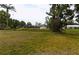 Expansive backyard with lush greenery and a serene waterfront view, perfect for outdoor enjoyment at 6309 35Th W Ave, Bradenton, FL 34209
