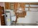 Utility Room features a sink, water heater and wood cabinetry at 6309 35Th W Ave, Bradenton, FL 34209