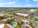 Community aerial featuring well-manicured landscaping, a shared pool, and nearby shopping centers at 6348 7Th W Ave # 6348, Bradenton, FL 34209