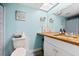 Bright bathroom with a skylight, wooden countertop, and beach themed decorations at 6348 7Th W Ave # 6348, Bradenton, FL 34209