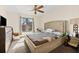 Bedroom featuring a ceiling fan, carpeted floors, and a large window for natural light at 6348 7Th W Ave # 6348, Bradenton, FL 34209