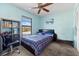 Bedroom with a blue accent wall, ceiling fan, large window, and furniture at 6348 7Th W Ave # 6348, Bradenton, FL 34209
