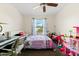 Bedroom features a ceiling fan, large window, and many toys at 6348 7Th W Ave # 6348, Bradenton, FL 34209
