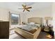Spacious bedroom with a ceiling fan, a large window, and an upholstered bed frame at 6348 7Th W Ave # 6348, Bradenton, FL 34209