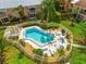 Stunning aerial view of a fenced-in community pool with lounge chairs and lush surroundings at 6348 7Th W Ave # 6348, Bradenton, FL 34209