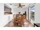 Charming dining area with hardwood floors, a glass table, wicker chairs, and natural light from a nearby window at 6348 7Th W Ave # 6348, Bradenton, FL 34209