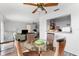 Bright dining area with glass table, wicker chairs, ceiling fan, and open access to a comfortable living space at 6348 7Th W Ave # 6348, Bradenton, FL 34209