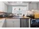 Well-lit kitchen with wood countertops, stainless steel dishwasher, and views through opening into adjacent living space at 6348 7Th W Ave # 6348, Bradenton, FL 34209