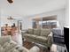 Open-concept living area with a comfortable sofa, hardwood floors, and windows offering a pleasant view at 6348 7Th W Ave # 6348, Bradenton, FL 34209