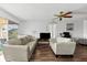 Spacious living room boasts hardwood floors, neutral walls, comfortable seating, and ample natural light from glass doors at 6348 7Th W Ave # 6348, Bradenton, FL 34209