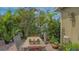 Backyard with patio, a garden table, greenery, and a home's exterior at 640 N Osprey Ave, Sarasota, FL 34236