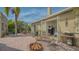 Inviting backyard featuring a brick patio, fire pit, outdoor seating, and access to the home through French doors at 640 N Osprey Ave, Sarasota, FL 34236