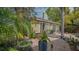 Lush backyard with brick patio, tropical plants, and French door access to the home at 640 N Osprey Ave, Sarasota, FL 34236